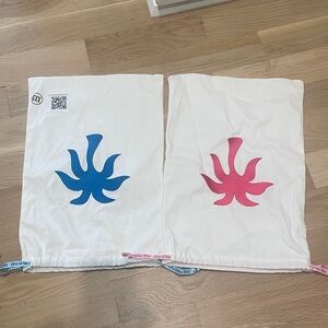 Stylish White Travel Bags with Blue and Pink Accents